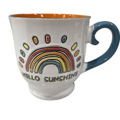 a coffee cup with the words hello sunshine painted on it and a rainbow in the middle