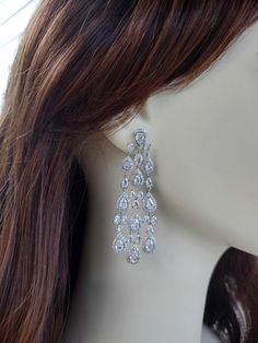 a close up of a mannequin head wearing some kind of earrings on it