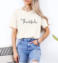 This Thankful t-shirt is the perfect shirt to add to your collection of Thanksgiving or Fall shirts this season. Printed on our favorite Bella + Canvas tee, the script word is written, followed by a small heart. Select colors are also available in Toddler and Youth sizes to make this the perfect family matching Thanksgiving shirt this season! With the large choice of fall color options, you are sure to find the perfect one you're looking for. *Note* Gold colored shirts might slightly vary in col Heart Graphic Short Sleeve T-shirt For Everyday, Fall Cotton T-shirt With Heart Graphic, Cotton Heart Graphic T-shirt For Fall, Cotton T-shirt With Heart Graphic For Fall, Fearfully Wonderfully Made, Thankful Heart, Thanksgiving Family, Fall Tee, Heart T Shirt