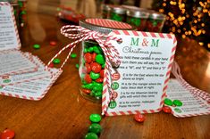 a jar filled with candy sitting on top of a wooden table next to christmas decorations