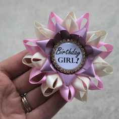 "Planning a birthday party? This handmade pin can be customized in your colors! You are welcome to leave a note during checkout regarding any color changes. Please see the chart in the pictures for all available ribbon colors. The pin shown is made from Ivory, Bubblegum and Thistle satin ribbon with a gold and crystal framed centerpiece. Each pin is 3 1/2\" wide and comes packaged in a cotton lined gift box with bow. See more birthday items here: http://www.etsy.com/shop/PetalPerceptions/search? Personalized White Craft Supplies For Birthday, Personalized Cute Craft Supplies For Birthday, Cute Personalized Craft Supplies For Birthday, Cute Personalized Craft Supplies For Birthdays, Cute Customizable Craft Supplies For Birthday, Cute Customizable Craft Supplies For Birthdays, Cute Purple Craft Supplies For Gifts, Cute Pink Party Supplies For Birthday Gift, Cute White Party Supplies For Gift