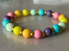 A pastel rainbow elastic glass bead bracelet, with metallic gold accent spheres to add some magic. This bracelet compliments any color and adds some delicate but playful touches to any bland outfit. If you'd like to order anything custom, which I also make, contact me at: -210-773-2555 -Vanitx@yahoo.com -message me from my shop (VCDesignsOnline) Glass Bead Bracelet, Glass Beaded Bracelets, San Antonio Tx, Gold Accent, Pastel Rainbow, Bead Bracelet, Glass Bead, Metallic Gold, San Antonio