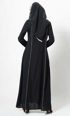 Featuring a flared elegant long abaya dress in nida fabric with contrast color flared panels on the sides and trims on the front. It has an A line silhouette perfect to be worn as casual everyday abaya.FIT : Relaxed fit.COMPOSITION : Nida.CARE : Dry clean only. Fitted Long Sleeve Black Abaya, Fitted Solid Maxi Length Abaya, Solid Color Abaya With Modesty Panel For Eid, Eid Abaya With Modesty Panel In Solid Color, Fitted Black Abaya For Eid, Long Abaya With Modesty Panel, Modest Fitted Black Abaya, Black Long Sleeve Maxi Dress For Eid, Black Abaya With Modesty Panel For Eid