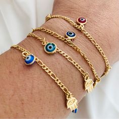 These Gold-Filled Evil Eye Bracelets Are Suitable For Protection And Negative Energies, They Bring The Hamsa Hand, An Ancient Amulet From The Middle East That Symbolizes The Hand Of God. They Come In Various Shades Of Blue And Red. Always Wear Your Bracelet And Protect Yourself From All Harm. Measurement: - Length: 7.5in - Evil Eye Width: 6.5mm - Hamsa Hand Width: 7mm - Figaro Link Width: 2.5mm Ancient Amulet, The Hand Of God, Eye Bracelets, Hand Of God, Bracelets Diy, Jewelry Lookbook, Beaded Bracelets Diy, Eye Bracelet, Evil Eye Bracelet