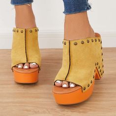 Step into retro-chic style with our Yellow Vegan Suede Platform Mules. Vintage-inspired and adorned with studded details, these heeled clogs elevate your fashion game effortlessly. Color: Yellow and orange Material: Vegan suede Heel Type: Chunky heel Heel height: 4.72" / 120 mm approx Product measurements were taken using size 8. Please note that measurements may vary by size. Toe: Open toe With Platform Studs embellishment design Handcrafted US sizing. Fits true to size. Trendy Clogs With Chunky Platform And Wedge Heel, Trendy Clogs With Chunky Platform And Open Heel, Trendy Clogs With Platform And Wedge Heel, Trendy Platform Clogs With Wedge Heel, Casual Sandals With Rivets And Round Toe, Casual Rivets Sandals For Spring, Trendy High Heels With Rivets, Retro Spring Platform Clogs, Yellow Casual Mules For Spring