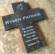 a wooden cross that has been placed on the ground with a poem written below it