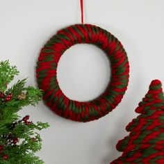 two christmas wreaths are hanging on the wall