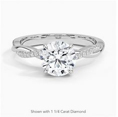 a white gold engagement ring with diamonds on the band and an oval cut diamond in the center