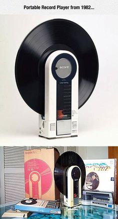 an old record player is sitting on top of a glass table with vinyl records in front of it