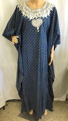 Vintage: 1960s 70s Caftan "Kaftan" Size: Medium Large Materials: Poly cotton blend  Color: Blue geometric Print Description:  Vintage Kaftan Maxi Dress.  Blue and Gold Geometric Print. Pretty white embroidery around neck line.  Very Slimming look.  High Neck.  Slip on No Zipper.   Great style wonderful look. Condition: Excellent. no tears or smells.  Please see pictures for more details Size: Not marked - Fits size small to large. Note: Slip on only No zipper.   This Kaftan is made to be more form fitting.  There is several inches of material on the outside to give it the free flowing look but is form fitting.  I have taken a picture of the dress "inside out"  To give a better idea of the fit. This is the LAST picture Please see measurements for proper fit Measurements: Shoulder 19" Chest Bohemian Maxi Dress With Dabka, Bohemian Tunic Dress With Dabka Detailing, Bohemian Dresses With Kimono Sleeves For Eid, Bohemian Floor-length Kimono For Eid, Bohemian Dabka Maxi Kaftan, Long Bohemian Kaftan With Dabka, Traditional Blue Maxi Dress For Eid, Festive Bohemian Maxi Length Thobe, Festive Bohemian Maxi Thobe