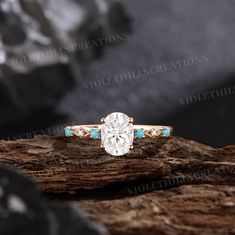 an oval cut diamond ring with turquoise accents