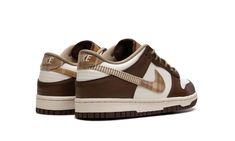 The Nike Dunk Low GS “Brown Plaid” is the youth sizing of the retro basketball shoe with a unique combination of materials in neutral colors.  The upper features a Sail leather base with contrasting brown leather overlays on the toe, forefoot, eyelets, collar, and heel.  A brown plaid material can be found on the Swoosh on either side of the shoe and on the heel tab.  Classic “Nike” branding appears on the heel and tongue.  The tongue is designed in a copper-colored corduroy material and outfitt Brown Dunks, Plaid Material, Plaid Shoes, Nike Branding, Retro Basketball Shoes, Corduroy Material, Retro Basketball, Nike Brand, Stadium Goods