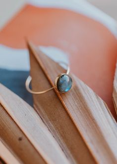 Our Dori ring is made with a gorgeous Labradorite stone. This mystical gemstone is believed to enhance mental clarity and bring about transformation. It's a crystal connected to the third eye chakra which is our gateway to inner wisdom and deeper intuition. 8mm round or 6x8mm oval labradorite stone. Ring band measures 1mm wide. Available in 14kt Gold Fill + Sterling Silver. KJ pairs it with our Sonder Ring, Raye Ring, and Confetti Ring. Handmade in Eau Claire, WI. Our jewelry is handmade so each Confetti Ring, The Third Eye Chakra, Copper Uses, Everyday Wear Jewelry, The Third Eye, Inner Wisdom, Stacking Bands, Handmade Jewelry Designs, Third Eye Chakra