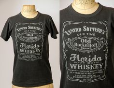 1970's Lynyrd Skynyrd Jack Daniels Whiskey Label Rock T Shirt Awesome early Skynyrd, on a pocket tee! 100% cotton. Made in USA. Marked as size Small. Measurements shoulders: 15" chest: 36" length: 25" Simple Man Tattoo Lynyrd Skynyrd, Whisky Label, Jack Daniels Tshirt, Lynyrd Skynyrd Shirt, Lynyrd Skynyrd Album Covers, Whiskey Shirt, Lynyrd Skynyrd Band, Whiskey Label, Rock T Shirt