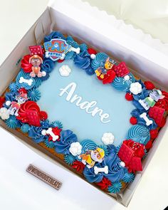 a birthday cake in a box with the name anane on it's side