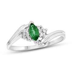 A marvelous choice for day or night, this charming gemstone and diamond ring makes creating a chic look easy. Crafted in 14K white gold, this graceful style features a rich 6.0 x 3.0mm marquise-cut verdant-green emerald. Trios of sparkling diamonds flank the center stone while the sculpted double ribbons of the shank bypass around the center. Radiant with 1/20 ct. t.w. of diamonds and a brilliant buffed luster, this ring gleams with exquisite design. Fine Jewelry Emerald Ring In White Gold With Diamond, Formal Emerald Solitaire Birthstone Ring, Classic Solitaire Diamond Ring For May Birthstone, Classic Diamond Ring With Accent Stones For May Birthstone, Marquise Emerald Ring In White Gold For Formal Occasions, Formal Marquise Emerald Ring In White Gold, White Gold Marquise Gemstone Ring, Oval Emerald Ring In White Gold With Diamond Accents, Formal Emerald Birthstone Ring With Center Stone