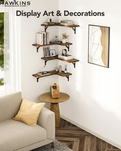 a living room filled with furniture next to a wall mounted book shelf on the side of a white wall