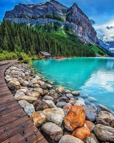 lake lousse, alberta canada with mountains in the background and rocks on the shore