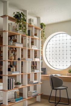 a book shelf with books and plants in front of a round window