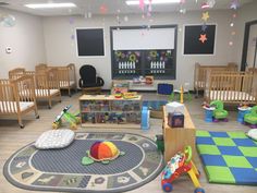 a child's playroom with toys and furniture in the room, including cribs