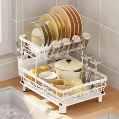 the dish rack is full of dishes and utensils