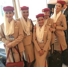 four air hostess standing next to each other