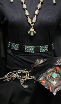 Vintage Navajo turquoise cowgirl belt-35" black leather with conchos-Western style Navajo Old Pawn jewelry. Old Pawn Navajo Turquoise Cluster Concho Belt. This belt comes from a distinguished Old Pawn collection, dating back to the 1940s-1950s. The absence of a maker's mark is typical for pieces of this vintage. The rectangular Conchos feature traditional Sterling silver backs with oxidized black plates, complemented by delicately polished handmade Sterling silver balls. The belt is currently on a new black leather strap, sized small. However, the Conchos can be easily transferred to a larger leather belt for personalized fitting. The turquoise stones are securely set throughout the belt, with only two cracked stones in the buckle that remain firmly in place. This belt, cherished over time Vintage Black Jewelry For Western-themed Events, Southwestern Concho Jewelry, Artisan Concho Jewelry, Black Southwestern Concho Jewelry, Southwestern Black Concho Jewelry, Black Concho Jewelry For Western-themed Events, Black Southwestern Jewelry With Turquoise Accents, Southwestern Turquoise Jewelry With Antique Buckle, Vintage Adjustable Turquoise Belt