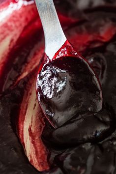 a spoon filled with chocolate and red liquid