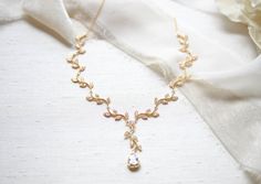 Lovely Rose gold dainty leaf Bridal necklace is perfect for any wedding or other special occasion. Romantic scrolled leaves encrusted with sparkly cubic zirconia stones. PLEASE ALLOW APPROX 10 BUSINESS DAYS FOR COMPLETION BEFORE SHIPPING.- Handcrafted with sparkly cubic zirconia components.- All clear stones - Rhodium, yellow gold or rose gold finish- Choose your necklace length from the drop down menu. Will come with a 2 inch extension chain on top of the length you choose.- Nickel free and hyp Rose Gold Delicate Bridal Necklace For Formal Occasions, Delicate Rose Gold Bridal Necklace For Formal Occasions, Feminine Rose Gold Wedding Necklaces, Elegant Rose-colored Wedding Necklace, Spring Flower-shaped Rose Gold Necklaces, Clear Stone, Bridal Necklace, Gold Finish, Cubic Zirconia