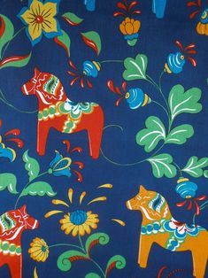 a blue background with colorful horses and flowers