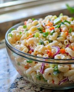 a bowl filled with macaroni salad on top of a table