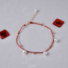 Unique designs of red string and gold chain bracelet with freshwater cultured pearls. All pearls are hand picked with very high luster and flawless surface. Symbolizing good luck, joy and happiness, these pearl red thread bracelets are perfect for Lunar New Year. Handmade in USA. Available in 2 styles. Style A: Half Thread Half Chain Pearl Bracelet ▷ 1 freshwater cultured white pearl with excellent luster and flawless surface. ▷ 1 AA+ quality freshwater pearl with good luster and flawless surfac Elegant Red Pearl Bracelets, Red Pearl Bracelets With Round Beads, Adjustable Red Jewelry With Pearl Charm, Red Pearl Bracelet As A Gift, Red Pearl Bracelet As Gift, Red Pearl Bracelet Gift, Red Pearl Beaded Bracelets As Gift, Red Pearl Bracelets As A Gift, Hand-strung Red Pearl Beaded Bracelets As Gifts