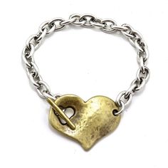 Two Tone Heart Bracelet | Gold Silver Heart Bracelet | Chunky Heart Bracelet | Heart Toggle Bracelet One of our most unique bracelets and a best seller! - Gold/bronze heart with silver chain - Brushed/matte silver plated pewter chain - brushed/matte gold bronze heart (bronze plated pewter) - comfortable toggle clasp - 7.5 inch length - very comfortable Matching necklace: https://www.etsy.com/listing/578368337/two-tone-heart-necklace-gold-silver?ga_search_query=heart+necklace&ref=shop_items_s Heart Bracelet Gold, Small Silver Earrings, Gold Heart Bracelet, Silver Heart Bracelet, Hammered Hoop Earrings, Chunky Bracelet, Bracelet Heart, Chunky Bracelets, Gold Heart Necklace