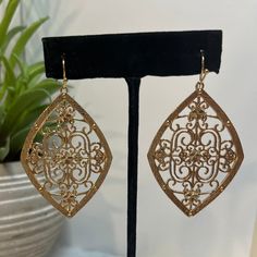 Make a statement with these Arabian Nights Earrings! Shimmering in gold, they feature a delicate filigree center and diamond shape that's sure to catch eyes -- guaranteed to give you an air of mystery and royalty! So why not take a night on the town with these on your ears? (After all, who doesn't love a little sparkle?) Spirit Wear, Arabian Nights, Curvy Dress, Midi Length Dress, Knee Length Dresses, Diamond Shape, Christmas And New Year, Love A, Holiday Fun