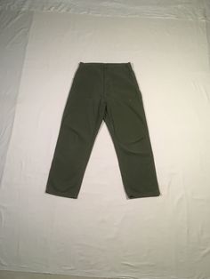 "vintage 1960s military trousers OG-107, Type 1, Class 1 green cotton button fly good vintage condition, light age wear fade, stains, fray smaller than tag size, see below, measures, lying flat, waist-17 1/2\" to 17 3/4\" with a tug rise-14\" insea-30\" hem-9\" outseam-43\" hip-22 1/2\"" Green Cotton Combat Cargo Pants, Green Combat Cotton Cargo Pants, Olive Military Style Pants For Streetwear, Green Military Style Cotton Bottoms, Green Military Cotton Bottoms, Vintage Style Solid Cotton Pants, Vintage Green Work Pants With Pockets, Vintage Green Pants For Streetwear, Vintage Green Cotton Work Pants