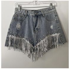 Denim Distressed Shorts From Shop Michella, Perfect For Any Cowgirl Or Western-Themed Occasion. The Shorts Feature A 5-Pocket Design And Button And Zip Closure, With Accents Such As Pearls, Fringe, Rhinestones, And Sequins. Medium Wash. New, With Tags. Perfect Condition. Spring Denim Blue Jeans With Rhinestones, Spring Rhinestone Denim Blue Jeans, Spring High Rise Jeans With Rhinestones, Spring High Rise Rhinestone Jeans, High Waist Rhinestone Denim Jeans, Casual Denim Blue Bottoms With Rhinestones, Trendy Denim Blue Bottoms With Rhinestones, Spring Denim Blue Bottoms With Rhinestones, Denim Blue Rhinestone Bottoms For Spring