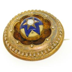 Here we have an amazing antique hair/picture locket from Victorian England. The piece is solid 15k yellow gold and has its original patina in tact. The piece has an Etruscan style design with a six pointed, champlevé, royal blue enamel work star. Bead set in the center of the star is a 3.4mm round genuine pearl. On the back there is a removable framed glass panel to facilitate the carry of a small photo or lock of hair. The glass is chipped but still fully functioning. The piece has both a pin o Victorian England, Picture Locket, Hair Locks, Bead Set, Pin Pendant, Glass Panel, Small Photos, Gold Hair, Hair Pictures