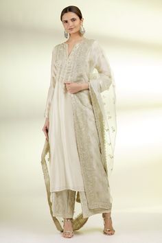 Beige kurta with embroidered motifs. Paired with embroidered palazzo and dupatta.
Components: 3
Fabric: Cotton Silk, Cotton, Organza
Neckline: Notched 
Sleeve Length: Three quarter
Color: Beige
Embroidered
Embroidered dupatta
Floral motif work
Lace trim detail - Aza Fashions Gopi Vaid, Beige Kurta, Organza Embroidery, Kurta Set For Women, Indian Designer Wear, Kurta Set, Trim Detail, Embroidered Silk, Designer Wear