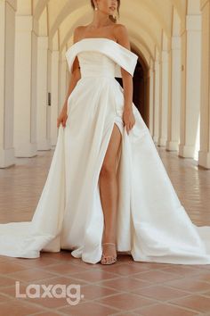 a woman in a white dress posing for the camera