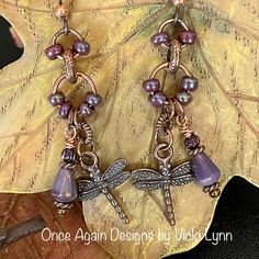 “Midsummer Eve Flight” - Dangle Earrings Hand Created - Once Again Designs By Vicki Lynn Limited Edition Dragonfly Earrings Reminiscent Of A Midsummer Eve. Iridescent Purple Glows In A Bath Of Warm Copper. This Pair: - Small Iridescent Purple Glass Beads. - Czech Glass Purple Bead Drops. - Copper Tone Metal Dragonfly Charm And Findings. - Tierracast Niobium Hypoallergenic French Hook Ear Wires With Copper Bead. - Length: Approximately 2-1/2” From Top Of Ear Wire To The Longest Bead Drop. Care: P Whimsical Nickel-free Purple Earrings, Whimsical Purple Nickel-free Earrings, Unique Purple Earrings With Dangling Beads, Whimsical Purple Drop Earrings, Elegant Purple Jewelry For Summer, Lavender Nickel Free Dangle Earrings, Elegant Purple Summer Jewelry, Lavender Nickel-free Dangle Earrings, Elegant Summer Purple Jewelry