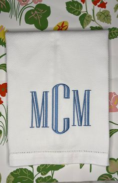 an embroidered monogrammed napkin with the word mcm on it