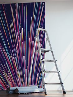 a ladder leaning against a wall with colorful sticks on it