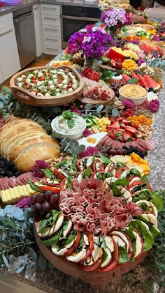 a long table filled with lots of different types of food on top of each other