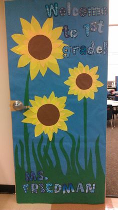 a door decorated with sunflowers and the words welcome to 1st grade