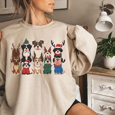 a woman wearing a sweater with dogs on it