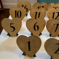 wooden hearts with numbers on them sitting on a table