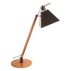 a desk lamp with a wooden base and black shade on the top, against a white background