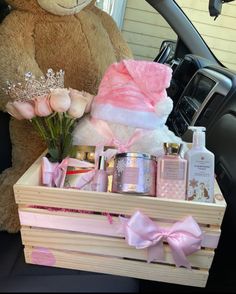 a teddy bear sitting in the back seat of a car next to a wooden crate filled with personal care items