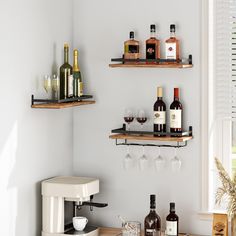 two shelves with wine glasses and bottles on them