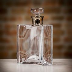 an empty glass bottle sitting on top of a table